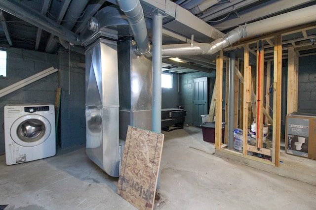 basement featuring washer / clothes dryer and heating unit