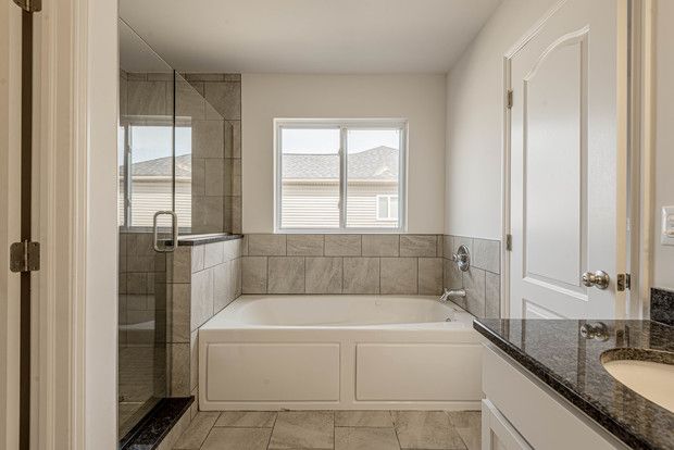 bathroom featuring vanity and shower with separate bathtub