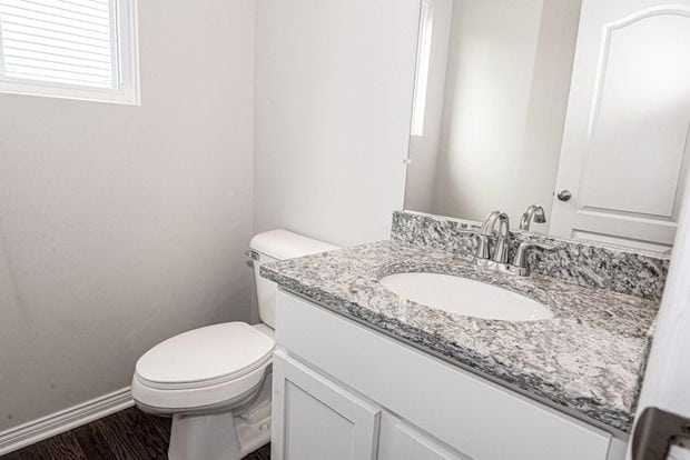 bathroom featuring vanity and toilet