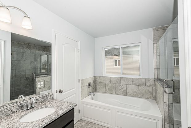 bathroom with plus walk in shower and vanity