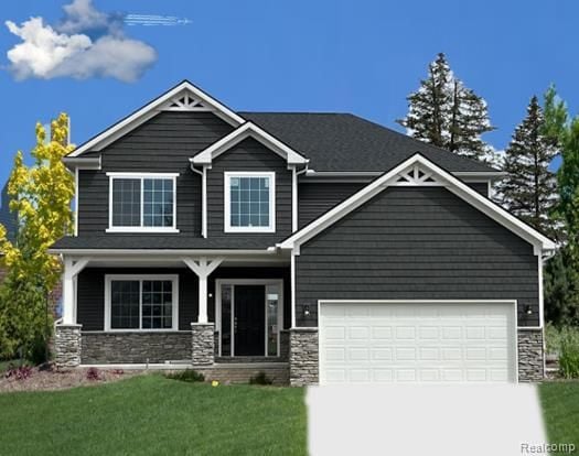 craftsman-style home with a front yard and a garage