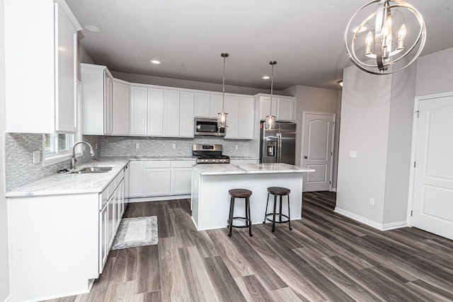 kitchen with white cabinets, a center island, and stainless steel appliances