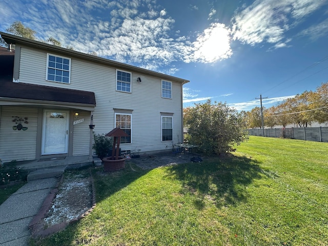 back of property featuring a lawn