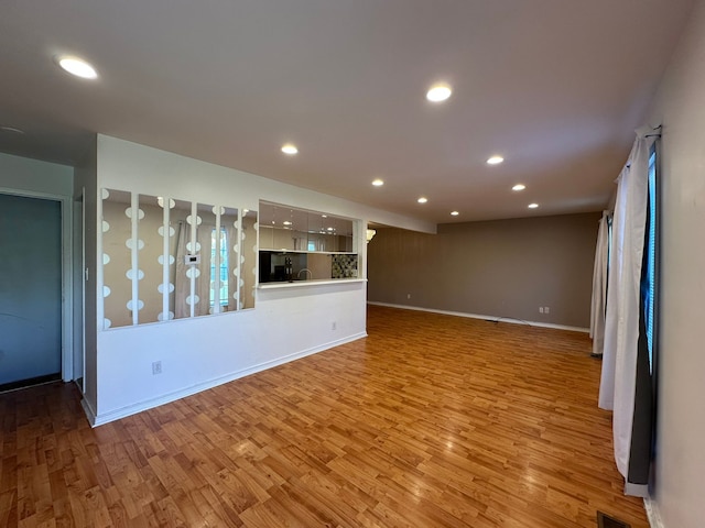 unfurnished living room featuring light wood-type flooring