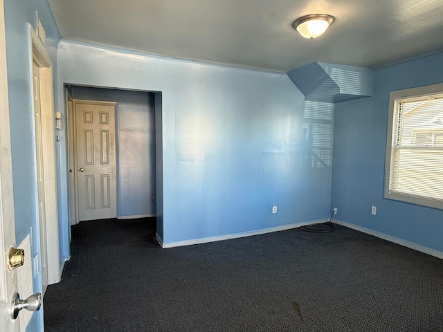 empty room featuring dark colored carpet