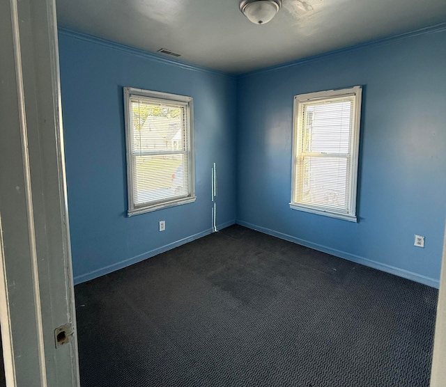 carpeted spare room featuring ornamental molding