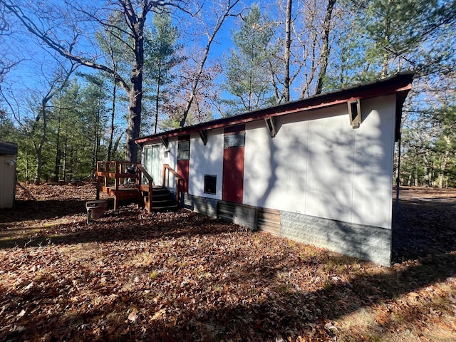 view of home's exterior with a wooden deck