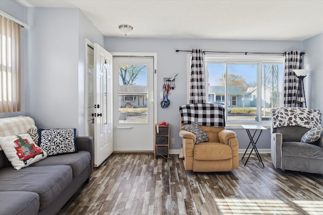 living room featuring plenty of natural light, dark hardwood / wood-style flooring, and a textured ceiling