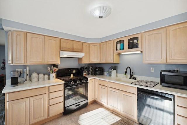 kitchen with sink, light brown cabinetry, light tile patterned floors, and appliances with stainless steel finishes