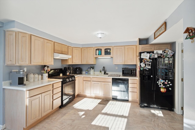 kitchen featuring light brown cabinetry, black appliances, and sink