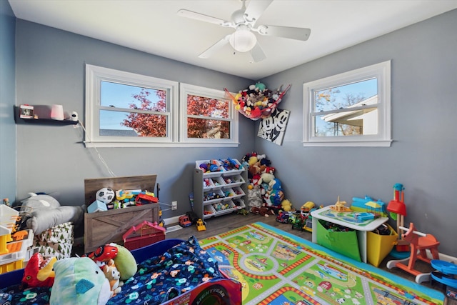 recreation room with hardwood / wood-style floors, a wealth of natural light, and ceiling fan