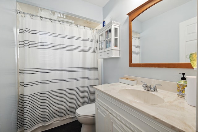 bathroom with vanity, toilet, and walk in shower