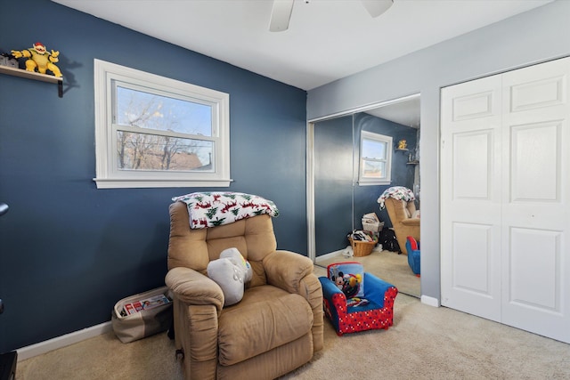 sitting room with light colored carpet and ceiling fan