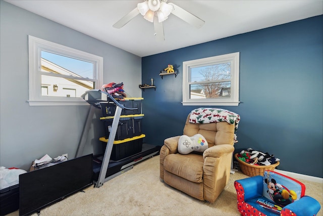 interior space with carpet floors and ceiling fan