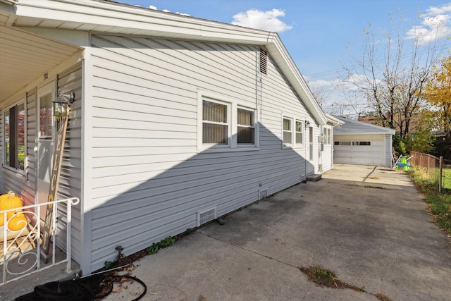 view of home's exterior featuring a garage and an outbuilding