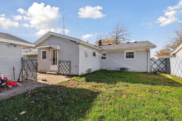 back of property featuring a yard and central AC unit