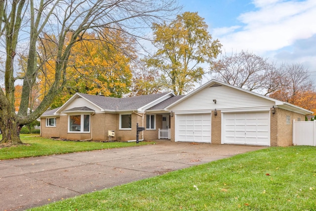 ranch-style home with a front lawn and a garage