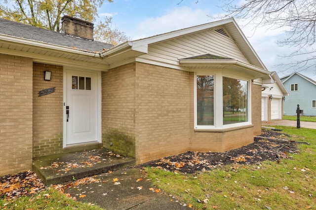 view of exterior entry with a garage