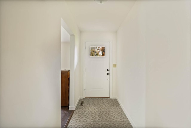 corridor with dark hardwood / wood-style flooring