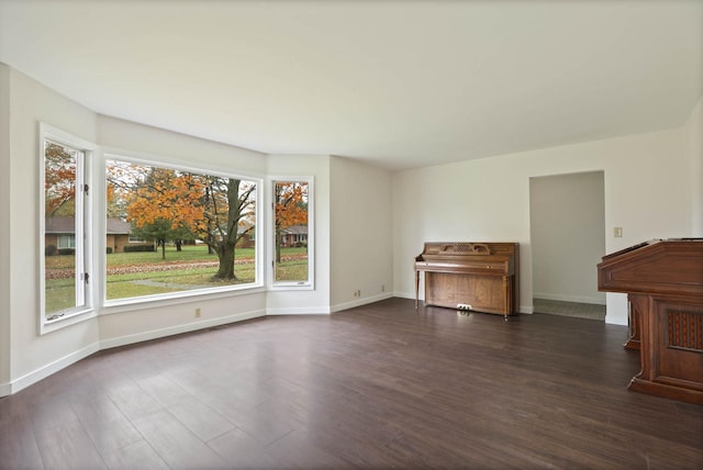 unfurnished living room with plenty of natural light and dark wood-type flooring