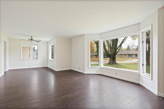 empty room featuring dark hardwood / wood-style floors and ceiling fan