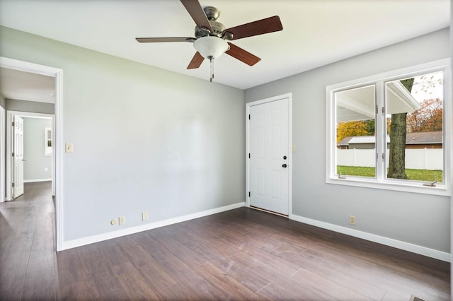 spare room featuring dark hardwood / wood-style floors and ceiling fan