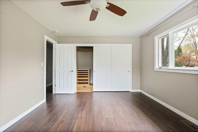 unfurnished bedroom with a closet, ceiling fan, and dark hardwood / wood-style flooring