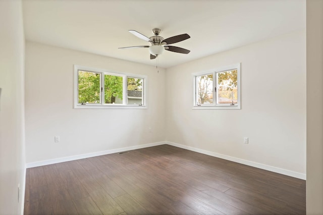 spare room featuring ceiling fan and dark hardwood / wood-style flooring