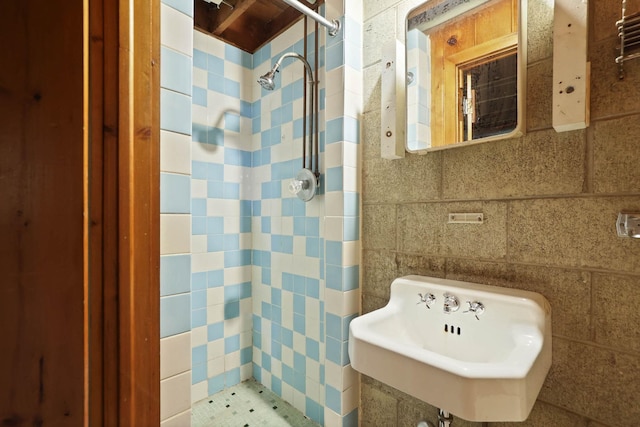 bathroom with tile walls and sink