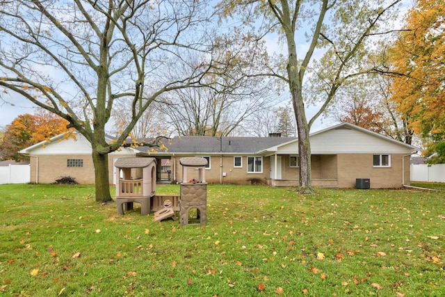 rear view of house featuring a yard