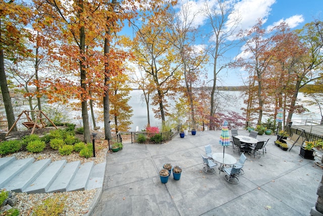 exterior space featuring outdoor dining space and fence