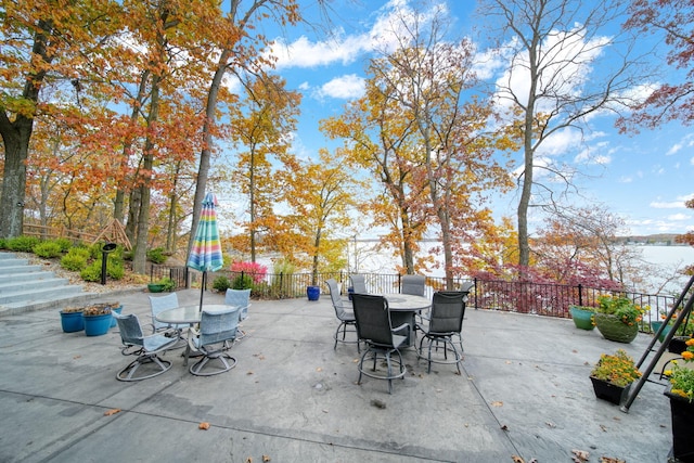 view of patio featuring outdoor dining space and fence