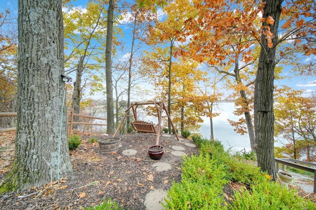 view of yard featuring a water view and fence