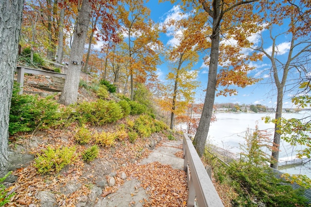 view of yard featuring fence and a water view