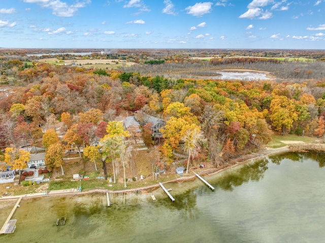 aerial view featuring a forest view and a water view