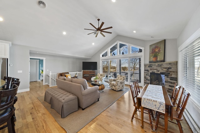 living area with a fireplace, visible vents, light wood finished floors, and baseboards