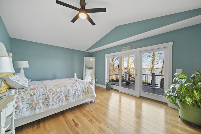 bedroom with access to exterior, vaulted ceiling, baseboards, and wood finished floors