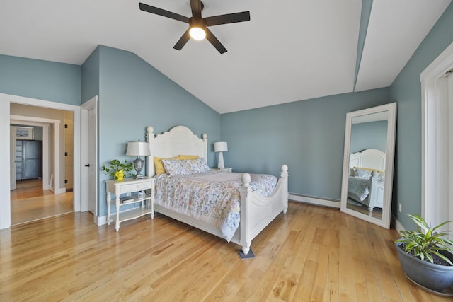 bedroom with lofted ceiling, baseboard heating, wood finished floors, and a ceiling fan