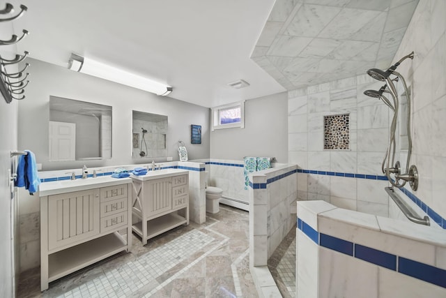 full bathroom featuring visible vents, toilet, a baseboard radiator, walk in shower, and vanity