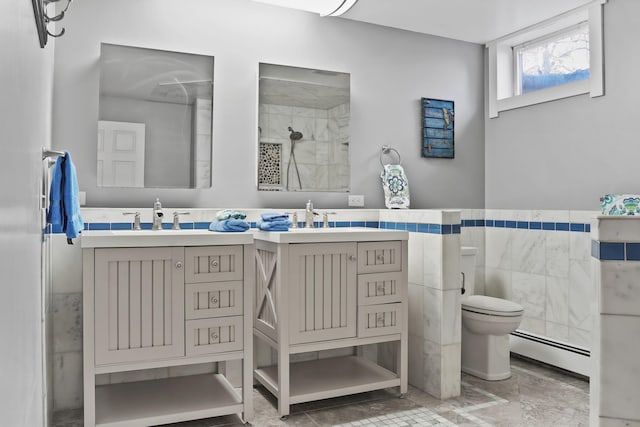 bathroom featuring vanity, tile walls, toilet, and a baseboard radiator