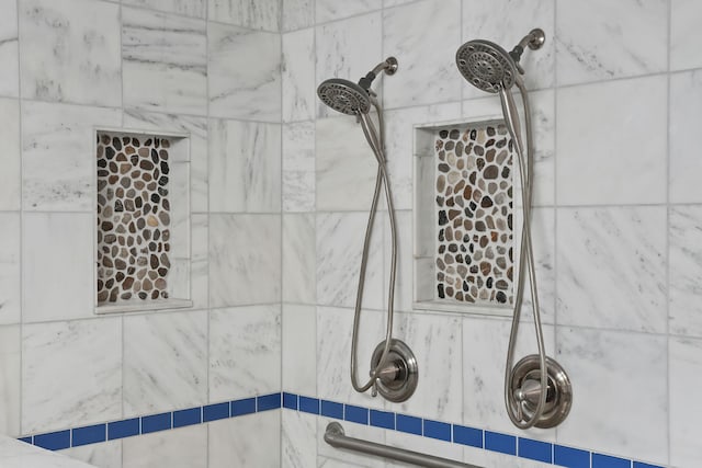 interior details featuring tiled shower