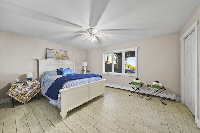 bedroom with ceiling fan, baseboards, light wood-type flooring, and a baseboard radiator