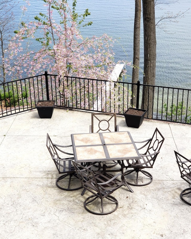 view of patio featuring outdoor dining space and a water view