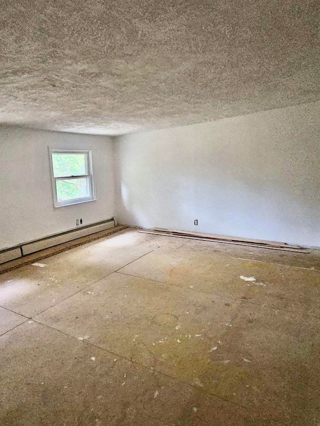 empty room featuring a textured ceiling and a baseboard radiator