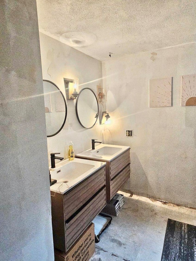 bathroom featuring a textured ceiling and vanity