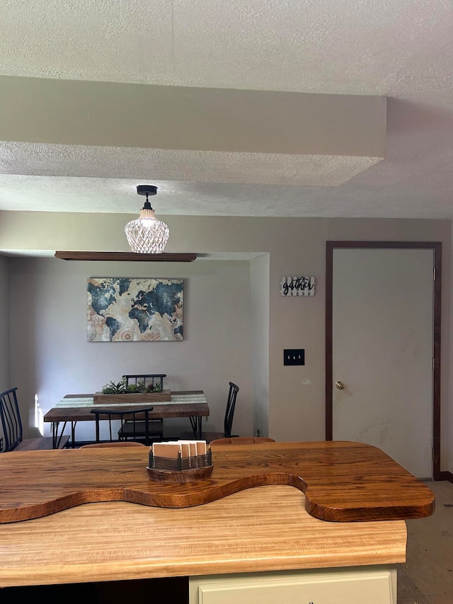 dining space with a textured ceiling