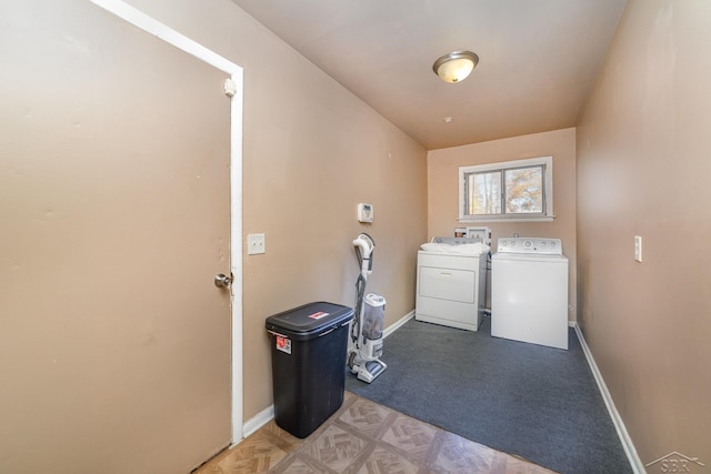 washroom with washing machine and dryer and carpet