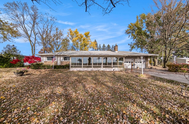 view of front of house featuring a carport and a sunroom