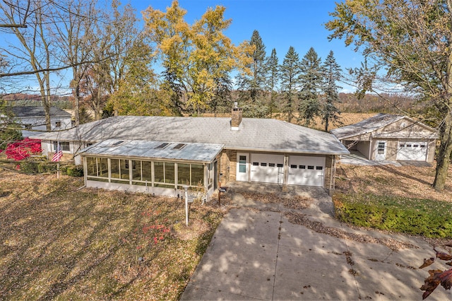 view of front facade with a sunroom and a garage