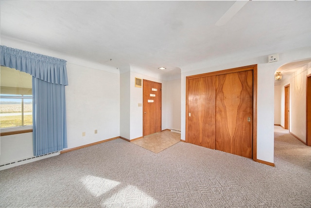 interior space featuring light colored carpet and a closet